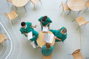 Healthcare staff communicating around a table