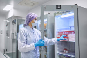 Medical employee with medicine refrigerator